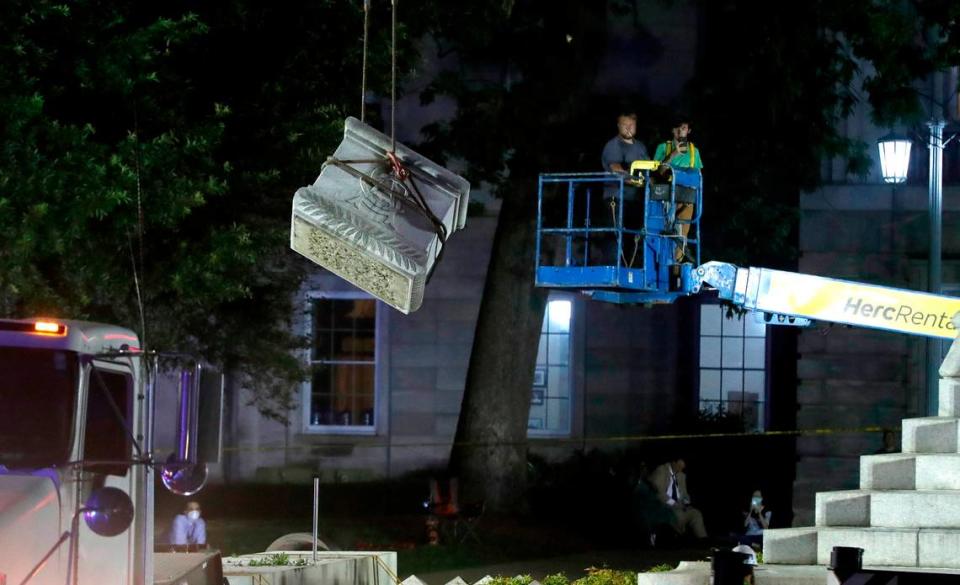 Crews remove a part of the Confederate monument on the grounds of the state Capitol in Raleigh, N.C., Tuesday evening, June 23, 2020. The 75-foot tall Confederate monument was removed after Gov. Roy Cooper cited public safety in ordering them to be taken down.