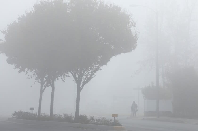 LA CANADA FLINTRIDGE, CA - DECEMBER 04: Morning fog on Foothill Boulevard in La Canada Flintridge on Saturday, Dec. 4, 2021. The fog has caused delays and cancellations of flights at Burbank Airport. (Myung J. Chun / Los Angeles Times)