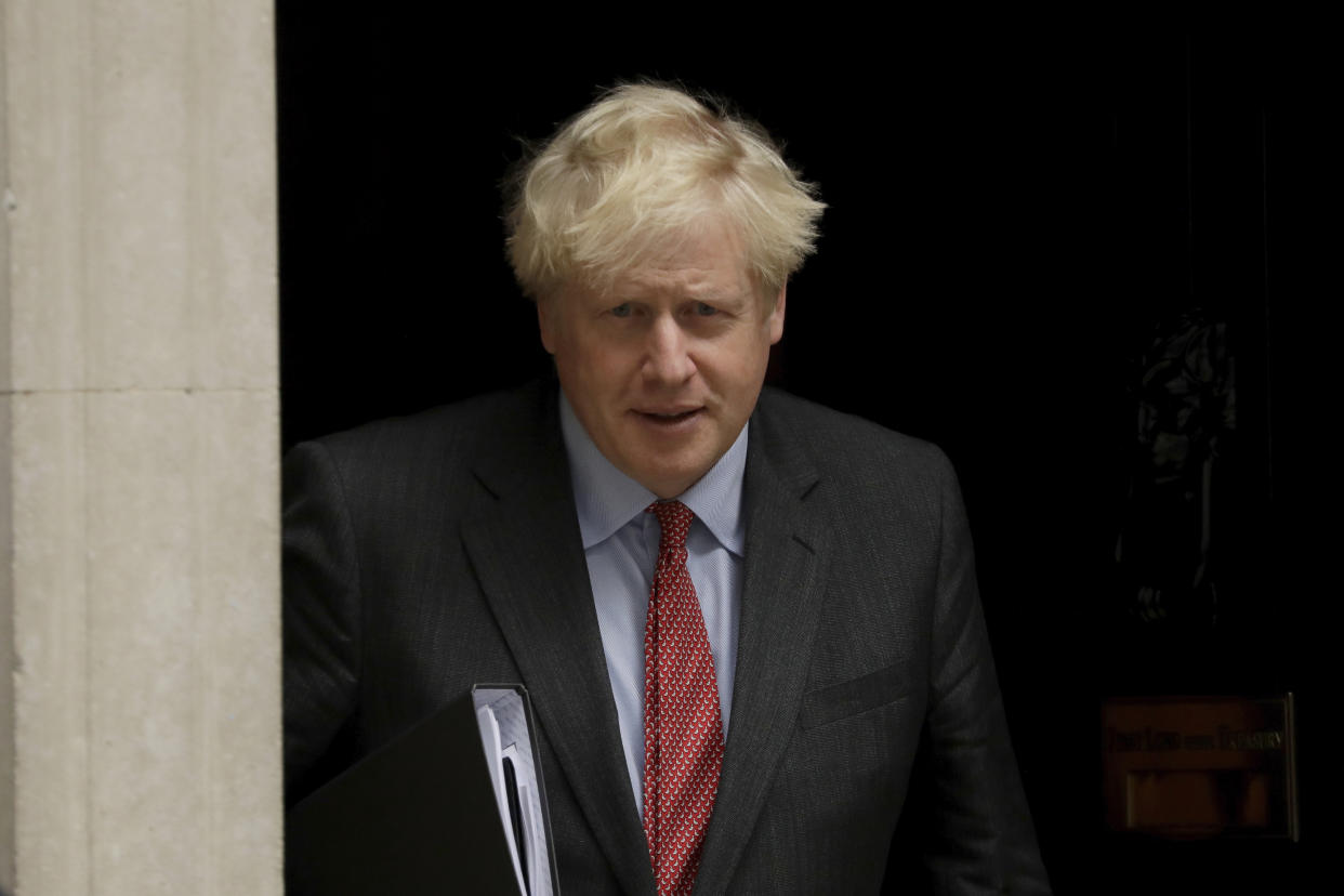 British Prime Minister Boris Johnson leaves 10 Downing Street, in London, to go to the Houses of Parliament to make a statement on new coronavirus restrictions Tuesday, Sept. 22, 2020. Johnson plans to announce new restrictions on social interactions Tuesday as the government tries to slow the spread of COVID-19 before it spirals out of control. (AP Photo/Matt Dunham)