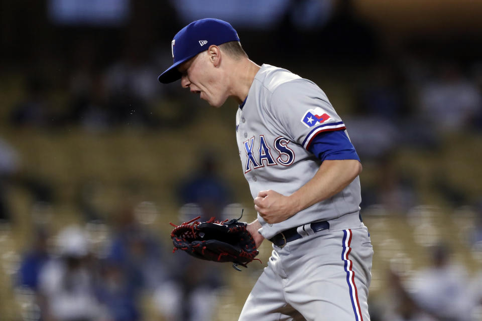 Texas Rangers starting pitcher Kolby Allard reacts after striking out Los Angeles Dodgers' Chris Taylor during the fifth inning of a baseball game in Los Angeles, Saturday, June 12, 2021. (AP Photo/Alex Gallardo)