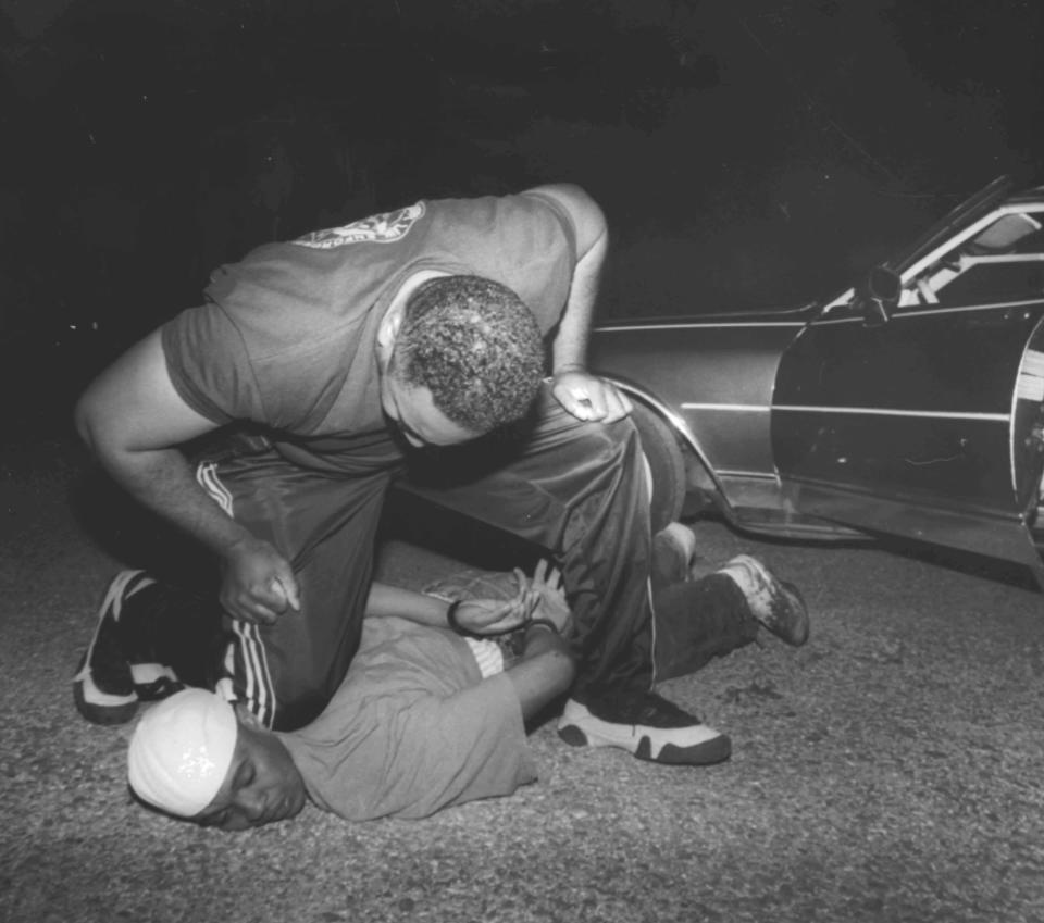 In this 2000 photo, Noxubee County Deputy Terry Grassaree kneels on the neck of Teronto Calhoun, a 20-year-old he arrested for resisting arrest.