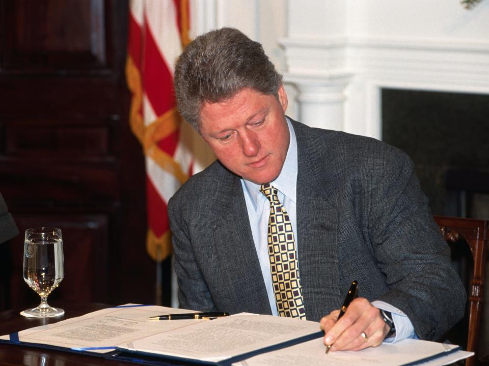 President Bill Clinton signing a bill into law