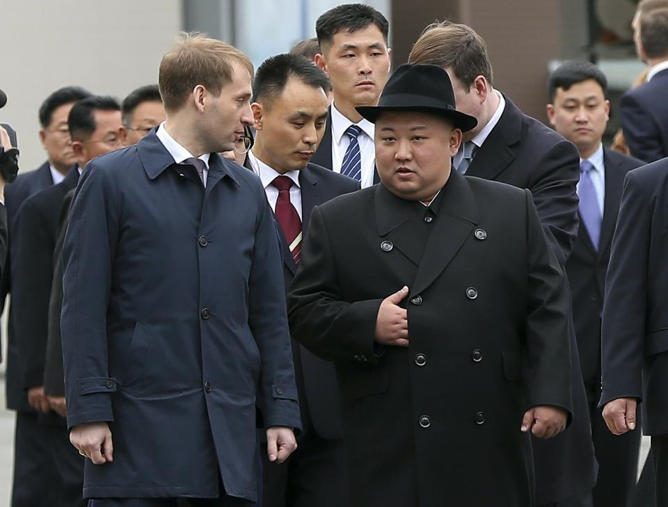 In this photo released by the press office of the administration of Primorsky Krai region, North Korea's leader Kim Jong Un, right, surrounded by Russian and North Korea's officials arrive in Vladivostok, Russia, Wednesday, April 24, 2019. North Korean leader Kim Jong Un arrived in Russia on Wednesday morning for his much-anticipated summit with Russian President Vladimir Putin in the Pacific port city of Vladivostok. (Igor Novikov/Press Office of the Primorye Territory Administration via AP)