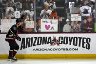 Arizona Coyotes' Dylan Guenther skates past fans as players warm up for an NHL hockey game against the Edmonton Oilers on Wednesday, April 17, 2024, in Tempe, Ariz. The Coyotes are moving to Salt Lake City in a deal that could be signed less than 24 hours after the game. Hockey could return, perhaps within five years, but the stark reality is this is the end for the foreseeable future. (AP Photo/Ross D. Franklin)