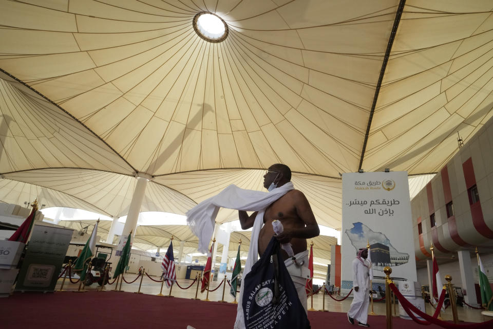 A pilgrim walks at the Hajj terminal of King Abdulaziz International Airport in Jeddah, Saudi Arabia, Tuesday, June 20, 2023. Saudi Arabia has ambitious plans to welcome millions more pilgrims to Islam's holiest sites. But as climate change heats an already scorching region, the annual Hajj pilgrimage could prove even more daunting. (AP Photo/Amr Nabil)