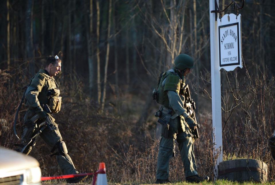PHOTO: Police check the scene at the aftermath of a school shooting at Sandy Hook Elementary School in Newtown, Conn., Dec. 14, 2012. (Don Emmert/AFP via Getty Images)