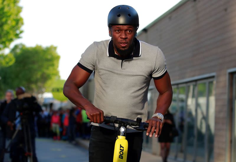 FILE PHOTO: Former sprinter Usain Bolt rides an electric scooter during the international launching of Bolt Electric Scooters by Bolt Mobility in Paris