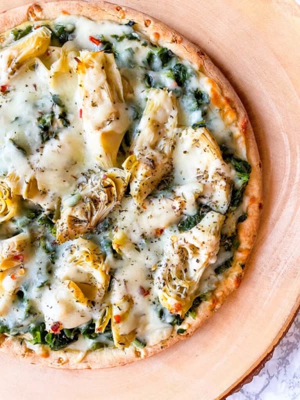 <p>Good Food Baddie</p><p>Using a chickpea crust makes this one your gluten-free guests can enjoy.<br><br></p><p><strong>Get the recipe: <a href="https://parade.com/1209499/kelli-acciardo/gluten-free-spinach-artichoke-pizza/" rel="nofollow noopener" target="_blank" data-ylk="slk:Spinach Artichoke Pizza;elm:context_link;itc:0;sec:content-canvas" class="link ">Spinach Artichoke Pizza</a></strong></p>