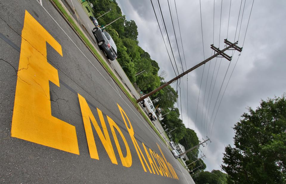 The phrase "End Racism Now" is painted on West Church Street in Dallas on June 22, 2020.