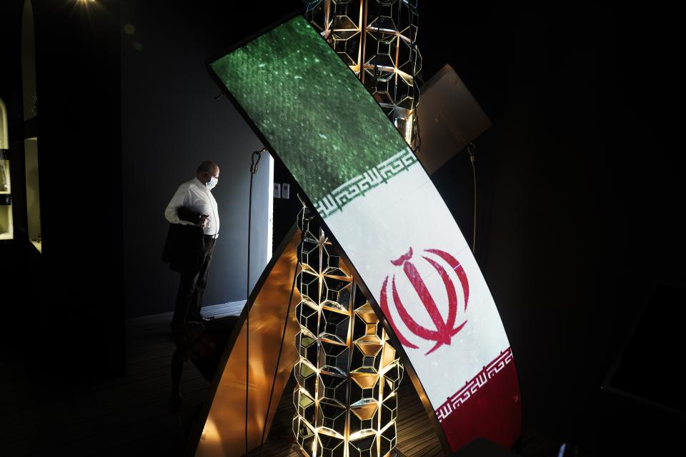 A man stands in an incomplete part of Iran's pavilion at Expo 2020 in Dubai, United Arab Emirates, Saturday, Oct. 2, 2021. Dubai has gambled billions to make the gleaming, built-from-scratch Expo village a triumphant tourist attraction and symbol of the United Arab Emirates itself — a feast for the eyes devoid of politics and built on the promise of globalization. But even as nations use their pavilions for benign infomercials, the political turbulence of the wider world somehow manages to intrude. (AP Photo/Jon Gambrell)