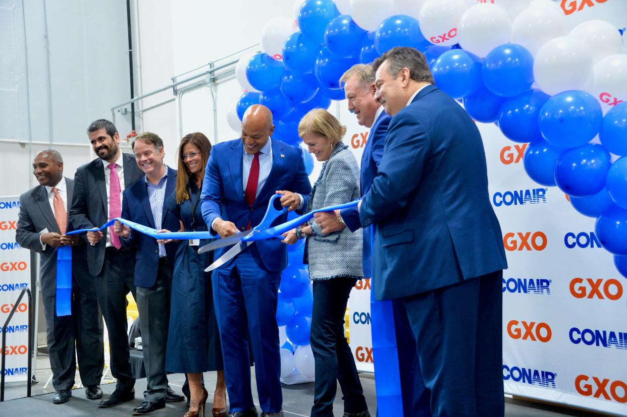 Gov. Wes Moore and Conair President and CEO Kristie Juster cut the ribbon Friday during the grand opening of Conair's more than 2.1 million-square-foot distribution center southwest of Hagerstown.