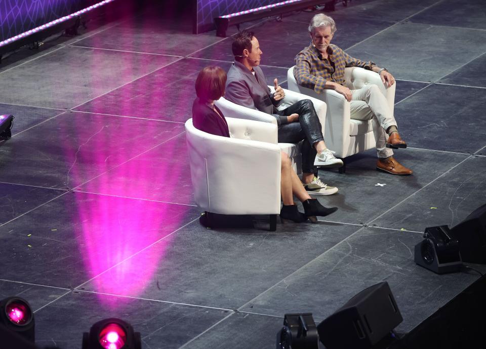 Caroline Klein, chief communications officer with the Utah Jazz, Jazz owner Ryan Smith and Reed Hastings, founder and executive chairman of Netflix, speak during the eighth annual Silicon Slopes Summit at the Delta Center in Salt Lake City on Wednesday, Sept. 27, 2023. | Jeffrey D. Allred, Deseret News