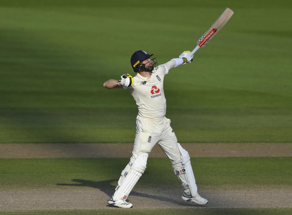 England's Chris Woakes celebrates their win on the fourth day of the first cricket Test match between England and Pakistan at Old Trafford in Manchester, England, Saturday, Aug. 8, 2020. (Dan Mullan/Pool via AP)