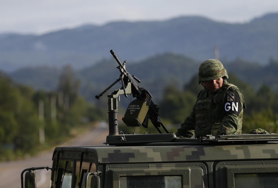 A soldier forming part of the National Guard mans an immigration checkpoint heading north out of Comitan, Chiapas state, Mexico, Sunday, June 16, 2019. Mexican President Andrés Manuel López Obrador said Saturday his country must help Central Americans fleeing poverty and violence, even as it increases security and revisions to deter migrants from passing through Mexico on route to the U.S. (AP Photo/Rebecca Blackwell)