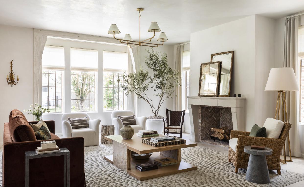  Modern rustic living room with neutral furniture and brick fireplace. 