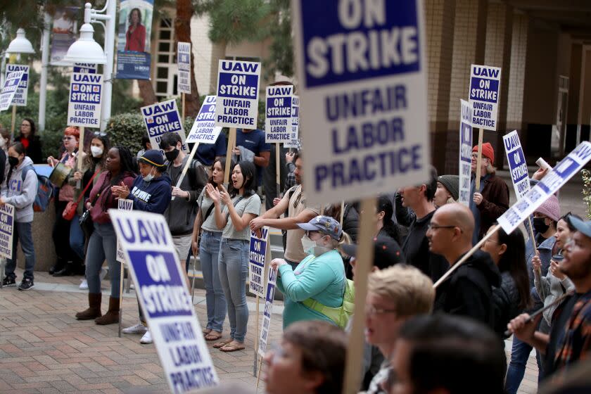 Irvine, CA - December 06: University of California picketers protest at University of California-Irvine in Irvine Tuesday, Dec. 6, 2022 in Irvine, CA. Strikers consist of members of by the United Auto Workers (UAW), which represents Academic Student Employees (Teaching Assistants/Associates, Readers, and Tutors), Graduate Student Researchers, Postdoctoral Scholars, and Academic Researchers (Academic Specialists, Project Scientists, and Professional Researchers). It's finals week for UC students and tens of thousands of academic workers remain on strike. This has put a huge wrench in how finals are administered, how undergraduates prepare for finals and when, how and if grades are submitted. Some faculty are standing in solidarity with striking workers and refusing to submit grades until an agreement is reached. (Allen J. Schaben / Los Angeles Times)