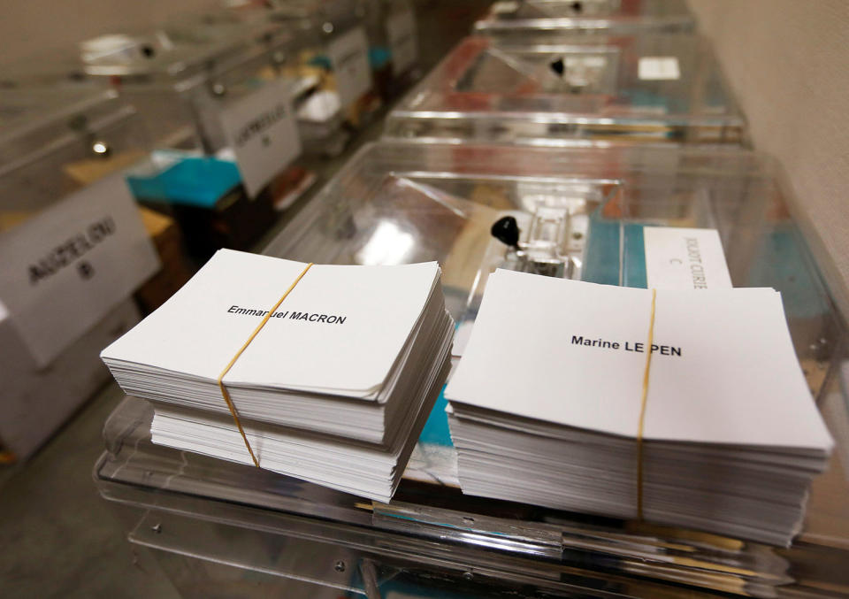 <p>Ballots with the names of 2017 French presidential election candidates Emmanuel Macron (L) and Marine Le Pen are seen near ballot boxes on the eve of the second round of the French presidential election, at a polling station in Tulle, France, May 6, 2017. (Photo: Regis Duvignau/Reuters) </p>