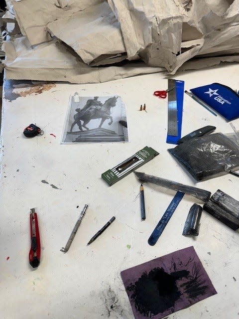 The worktable in Pratt Munson artist-in-residence Felipe Lopez's private studio is scattered with materials and works-in-progress.