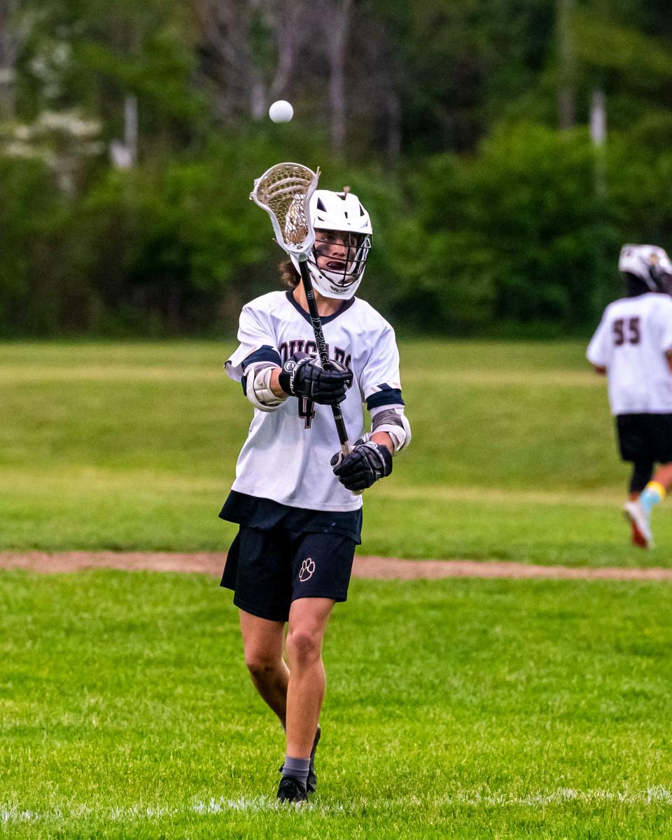 Old Colony's Stu Burnham moves the ball around the field for the Cougars last year.