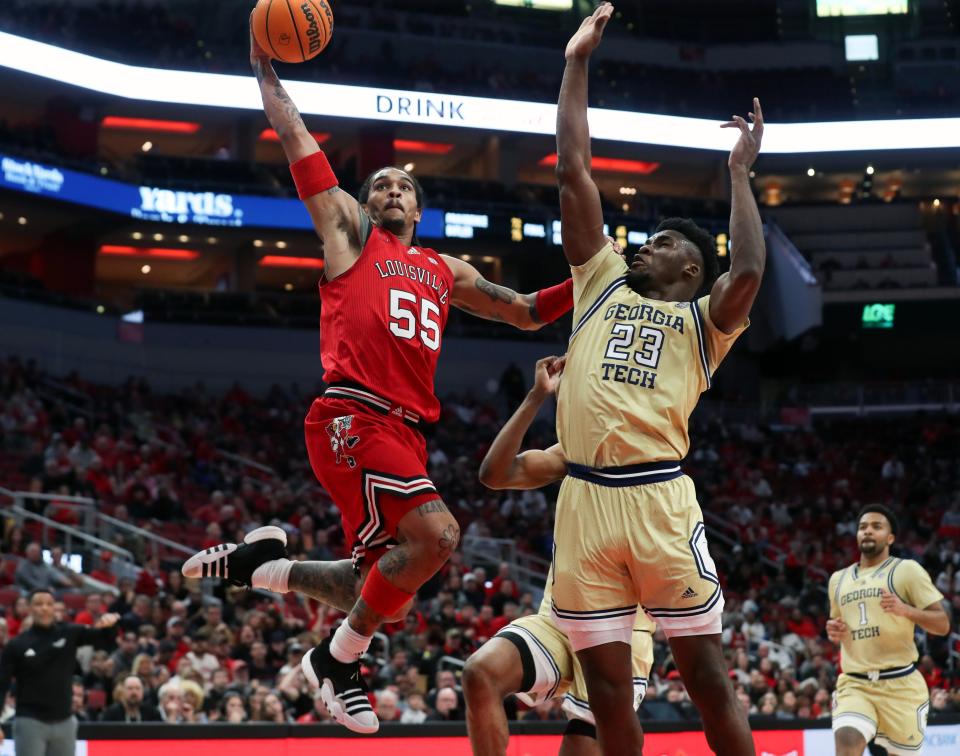 Louisville’s Skyy Clark is fouled by Georgia Tech’s Ibrahima Sacko on Saturday night. Clark scored 11 points in the Cardinals' home win.