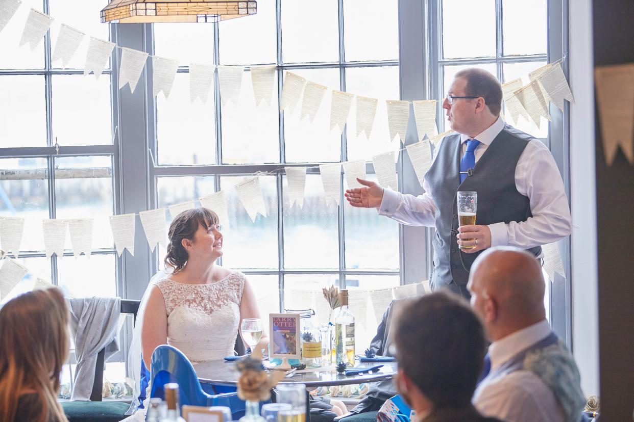 Amy Fieldhouse-Downes and husband James, pictured with bunting made from Harry Potter book pages. (Supplied)