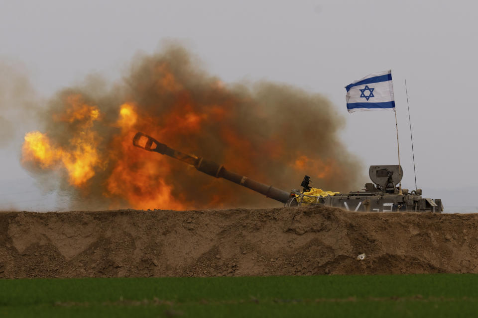 An Israeli mobile artillery unit fires a shell from southern Israel towards the Gaza Strip, in a position near the Israel-Gaza border on Thursday, Dec. 21, 2023. (AP Photo/Ohad Zwigenberg)