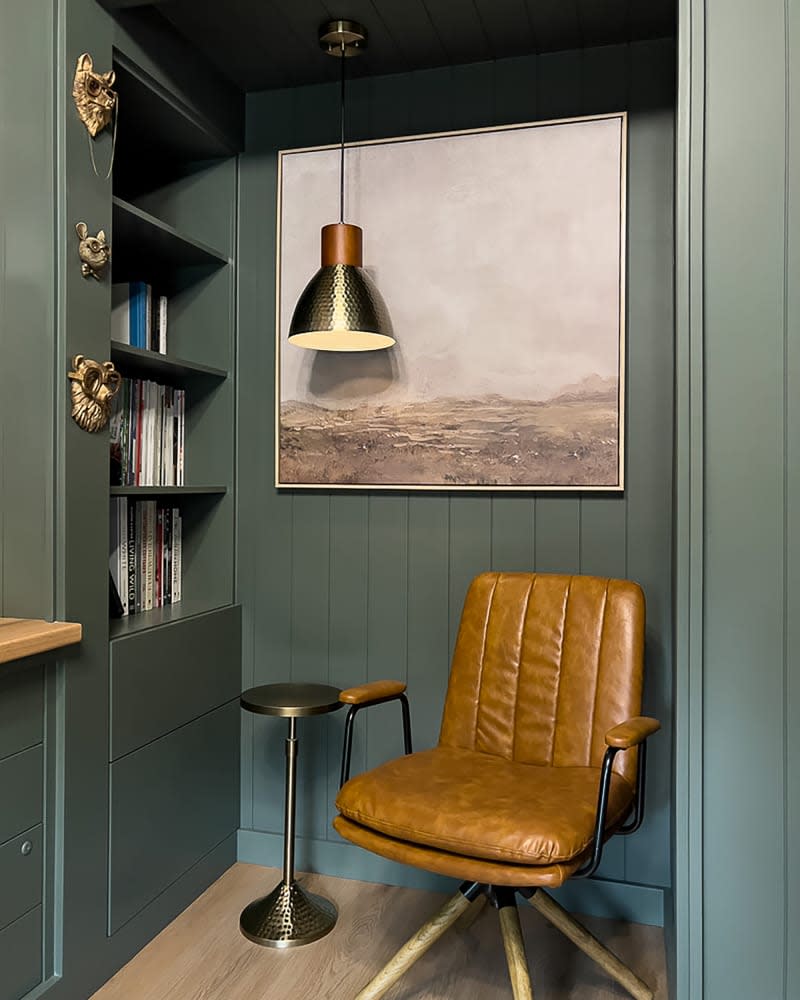 Pendant lamp above leather arm chair in newly renovated office.