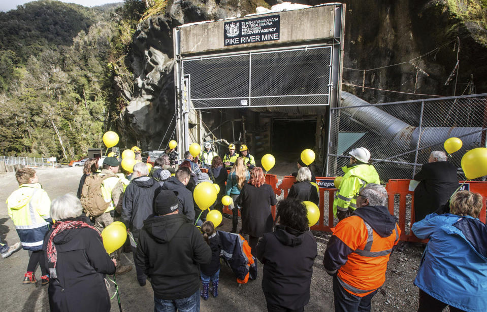 In this image released by the Pike River Recovery Agency, families gather at the entrance of the Pike River Mine, near Greymouth on the West Coast of New Zealand, Tuesday, May 21, 2019. Crews in New Zealand on Tuesday reentered an underground coal mine where a methane explosion killed 29 workers more than eight years ago, raising hopes among family members that they might find bodies and new evidence that leads to criminal charges. (Neil Silverwood/Pike River Recovery Agency via AP)