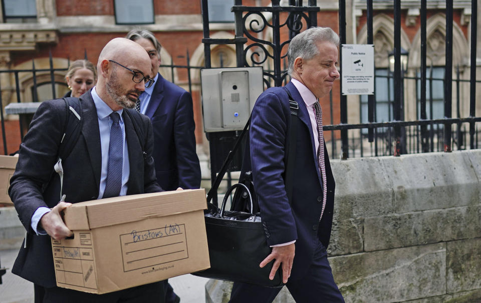 Christopher Steele, right, leaves the Royal Courts of Justice after the first hearing in Donald Trump's High Court claim against the former MI6 officer's intelligence consultancy, in London, Monday, Oct. 16, 2023. A lawyer for Donald Trump has told a London judge that the ex-president plans to prove that a “shocking and scandalous” report by a former British spy was wrong and harmed his reputation. Trump has sued the company founded by Christopher Steele, who created a dossier in 2016 that contained rumors and uncorroborated allegations about Trump that erupted in a political storm just before his inauguration. (Aaron Chown/PA ia AP)