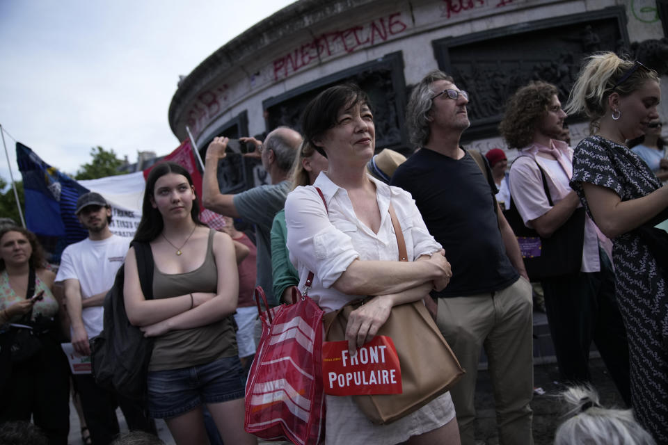 People gather on the Republique Plaza during a rally in Paris, Thursday June 27, 2024. Anti-racism groups joined French unions and left-wing coalition in protests against the surging nationalist far right as French President Emmanuel Macron called snap elections following the defeat of his centrist alliance at European Union elections earlier this month. (AP Photo/Christophe Ena)