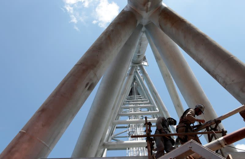 FILE PHOTO: Employees work on the final stage of the construction of the new P-56 semi-submersible production platform for the oil company Petrobas at the Brasfels shipyard in Angra dos Reis