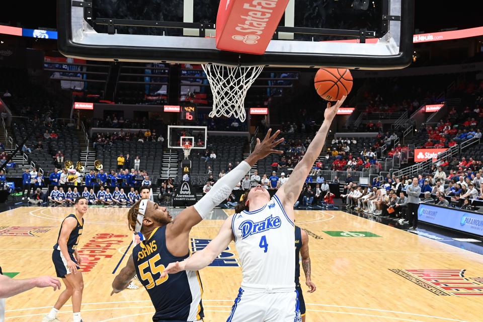 Drake's Conor Enright (4) goes up for a shot while Murray State's DJ Burns (55) defends. Enright had difficulty standing and was helped to the locker room after this shot.