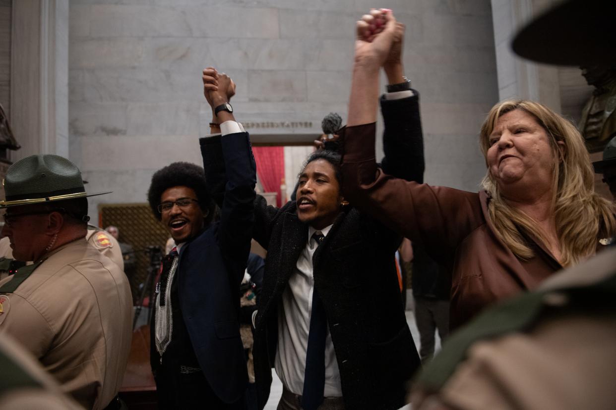 Rep. Justin Pearson, Rep. Justin Jones, Rep. Gloria Johnson People hold their hands up as they exit the House Chamber doors at Tennessee State Capitol Building in Nashville , Tenn., Monday, April 3, 2023.