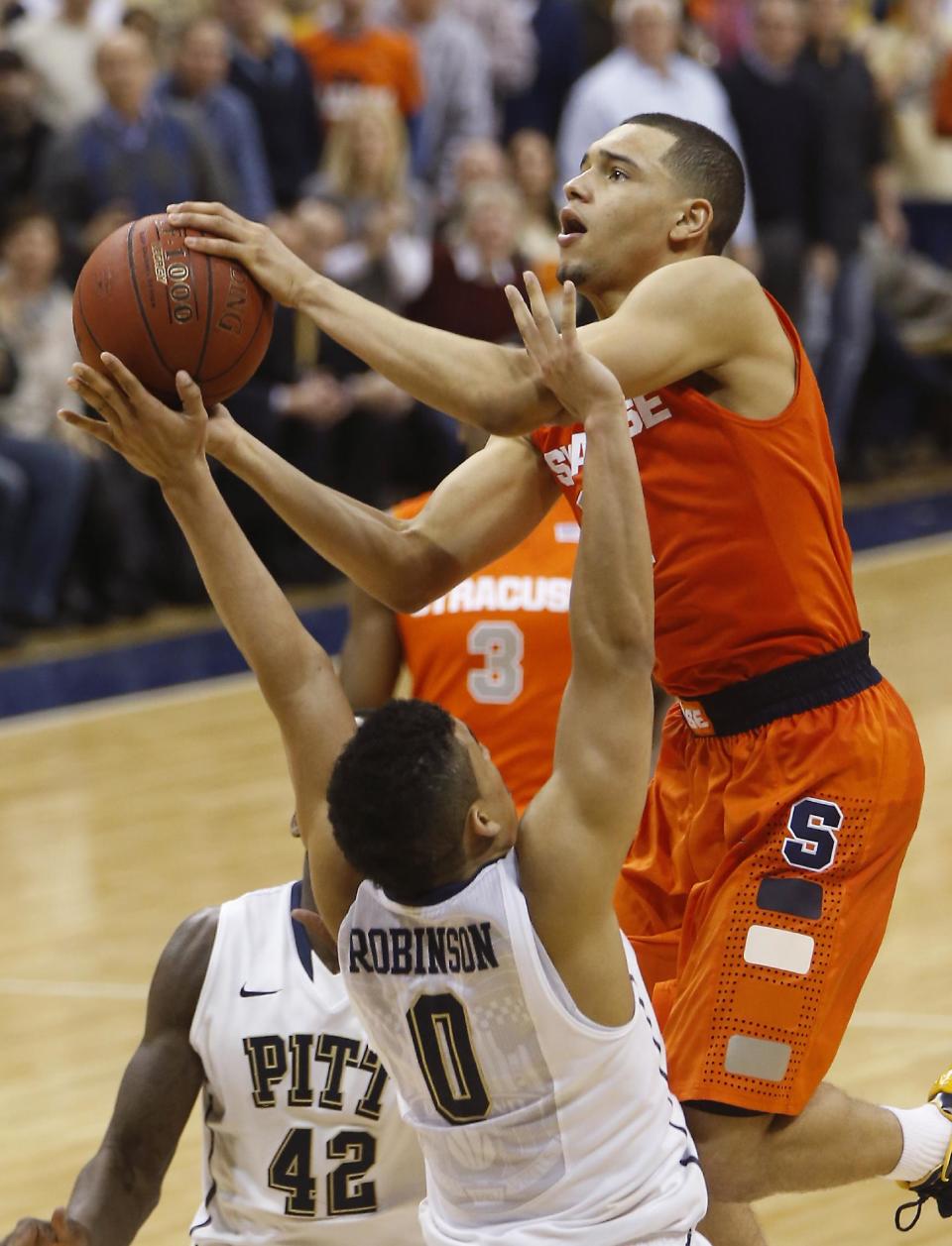 Syracuse's Tyler Ennis shoots over Pittsburgh's James Robinson (0) during the second half of an NCAA college basketball game Wednesday, Feb. 12, 2014, in Pittsburgh. Syracuse won 58-56. (AP Photo/Keith Srakocic)