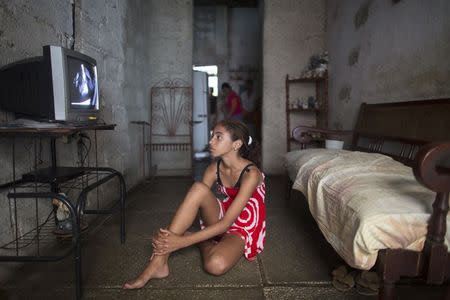 Jenifer Lopez, 12, watches television at her home in Havana January 9, 2015. REUTERS/Alexandre Meneghini