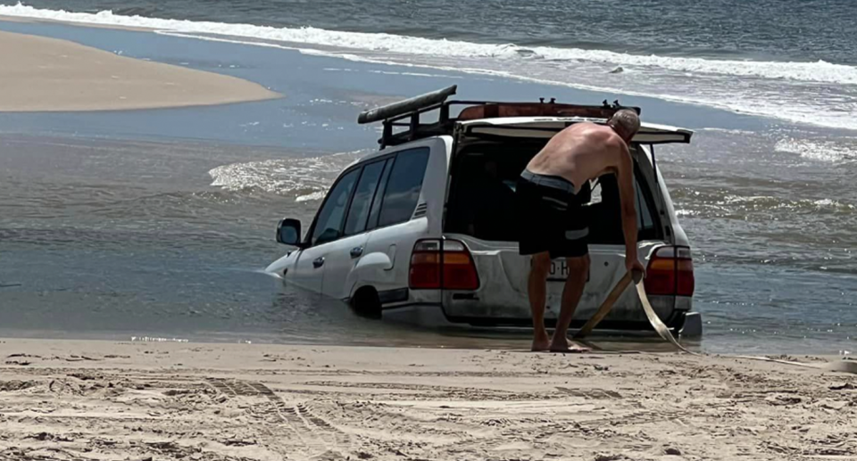 A Toyota Land Cruiser submerged in metre-deep water on Bribie Island on Thursday. 