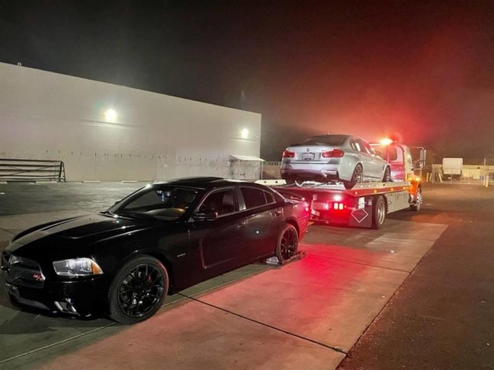 A vehicle is towed away on Friday, Dec. 3, 2021, after what police said was an illegal sideshow in North Natomas, California.