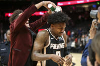 Atlanta Hawks guard Trae Young, left, pours water on guard Brandon Goodwin (0) after a 102-95 victory in an NBA basketball game against the Los Angeles Clippers, Wednesday, Jan. 22, 2020, in Atlanta. (AP Photo/Brett Davis)