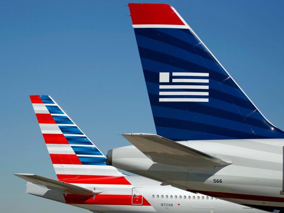 American Airlines and US Airways tail sections.