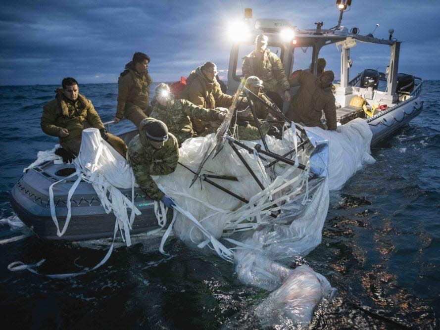 Sailors assigned to Explosive Ordnance Disposal Group 2 recover a high-altitude surveillance balloon off the coast of Myrtle Beach, South Carolina, Feb. 5, 2023.