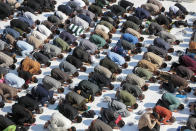 Supporters of the Shiite cleric Muqtada al-Sadr pray during Friday prayers at a mosque in Kufa, Iraq, Friday, Dec. 2, 2022. Al-Sadr who announced his withdrawal from politics four months ago has broken a period of relative silence to launch an anti-LGBTQ campaign. (AP Photo/Anmar Khalil)