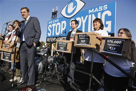 U.S. Representative Justin Amash (R-MI) (L) smiles as he accepts a petition organizers said represented 575,000 people calling for congressional hearings about U.S. spy programs, as he addresses the "Stop Watching Us: A Rally Against Mass Surveillance" near the U.S. Capitol in Washington, October 26, 2013. REUTERS/Jonathan Ernst