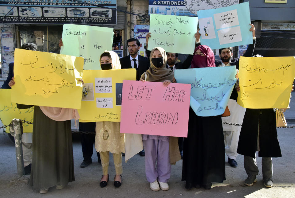 Afghan university students chant slogans and hold placards during a protest against the ban on university education for women, in Quetta, Pakistan, Saturday, Dec. 24, 2022. (AP Photo/Arshad Butt)