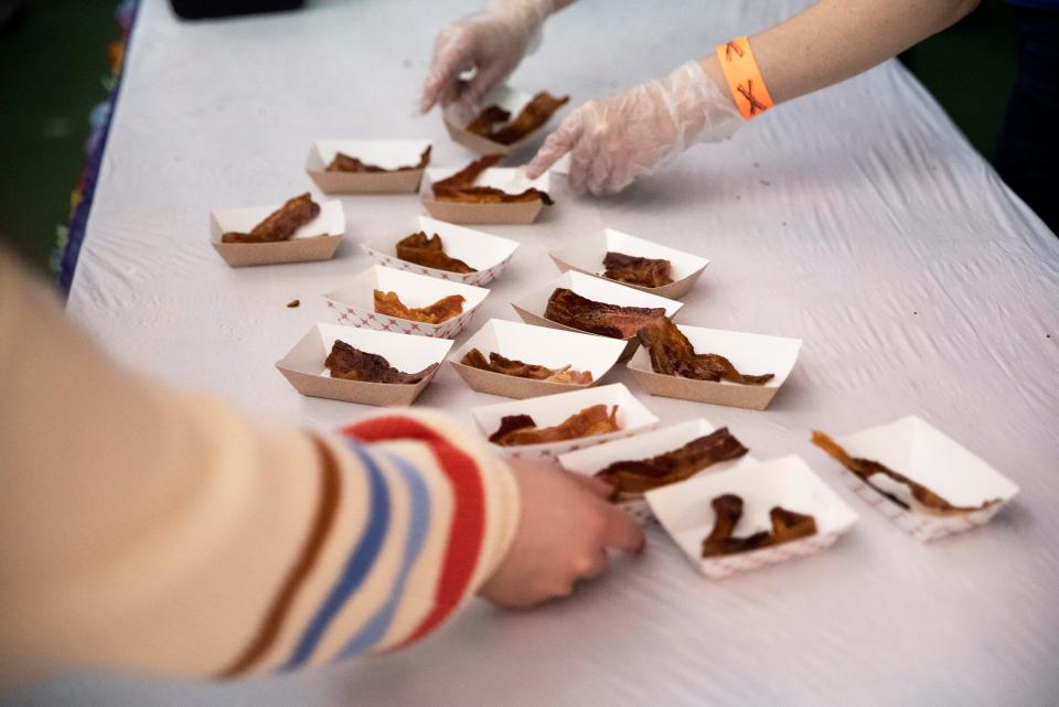 Attendees of the Blue Ribbon Bacon Festival sample bacon on Mar. 7, 2020 at the Horizon Events Center in Clive.