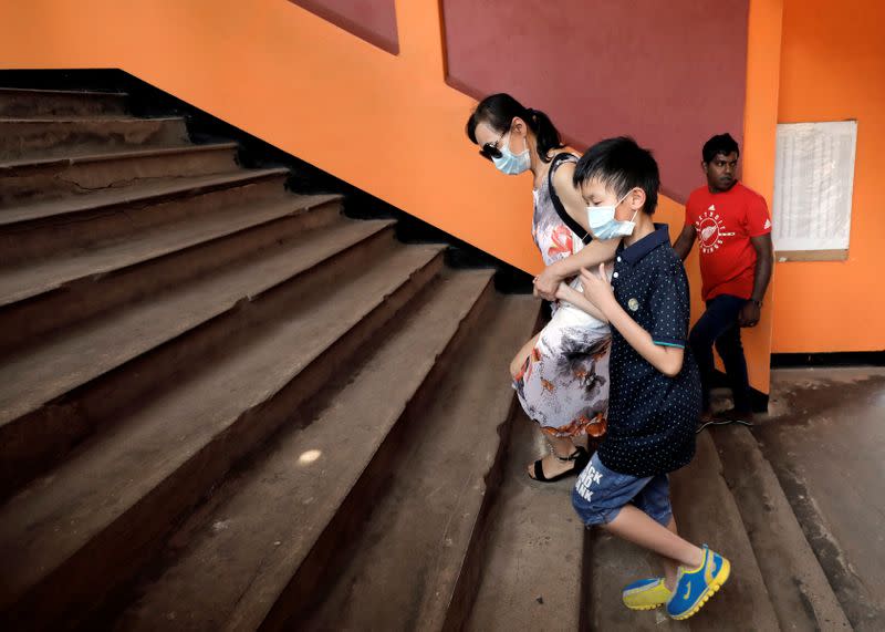 Chinese tourists wear facial masks as they leave a train station, after Sri Lanka confirmed the first case of coronavirus in the country, in Colombo