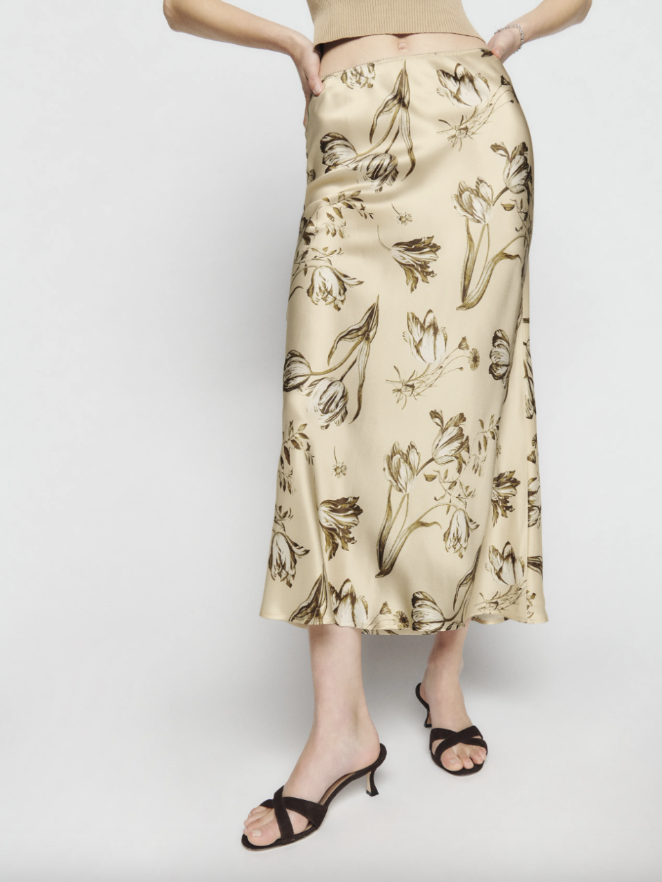 model wearing beige and brown printed Layla Silk Skirt (Photo via Reformation)