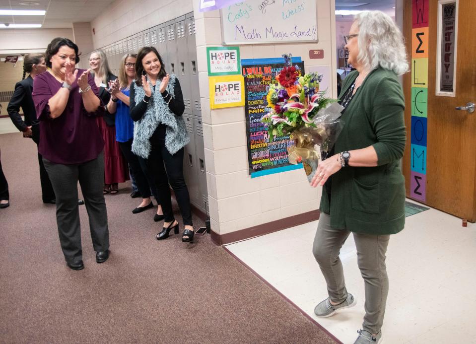 Navarre High School teacher Karen Cody is congratulated by her colleagues after being named the district Teacher of the Year on Wednesday, Jan. 25, 2023.