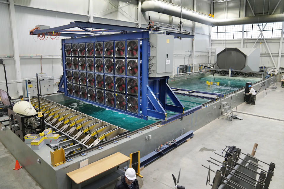 A bank of powerful fans and 16 mechanical paddles are used to simulate in a pool the worst conditions at sea, Wednesday, March 27, 2024, at the University of Maine, in Orono, Maine. (AP Photo/Robert F. Bukaty)