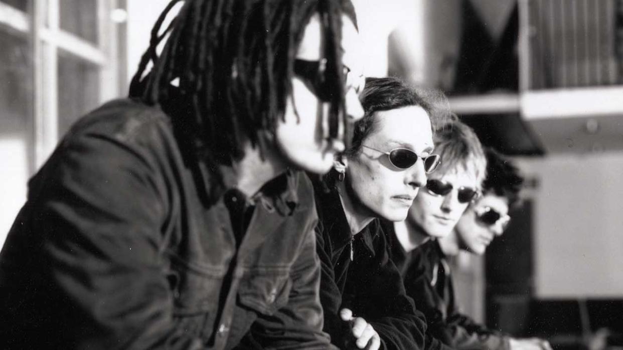  A portrait of Swervedriver in 1998. The band are sat down and all wearing sunglasses. 