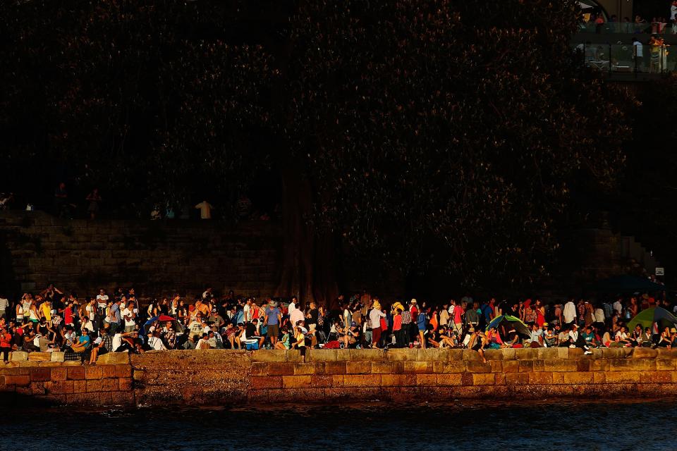 SYDNEY, AUSTRALIA - DECEMBER 31: People line the harbour in anticipation of New Years Eve celebrations on Sydney Harbour on December 31, 2012 in Sydney, Australia. (Photo by Brendon Thorne/Getty Images)